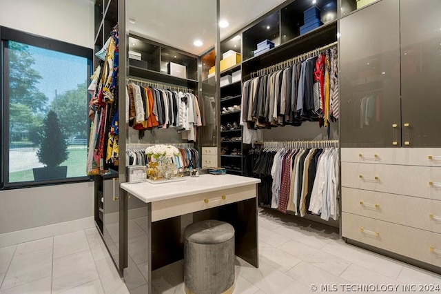 spacious closet featuring light tile patterned flooring