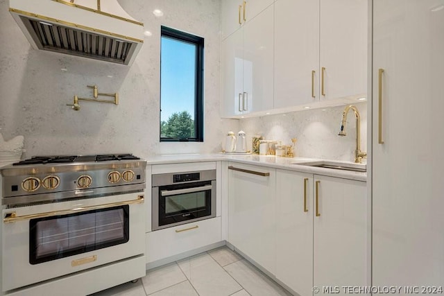 kitchen with sink, white cabinets, extractor fan, and appliances with stainless steel finishes