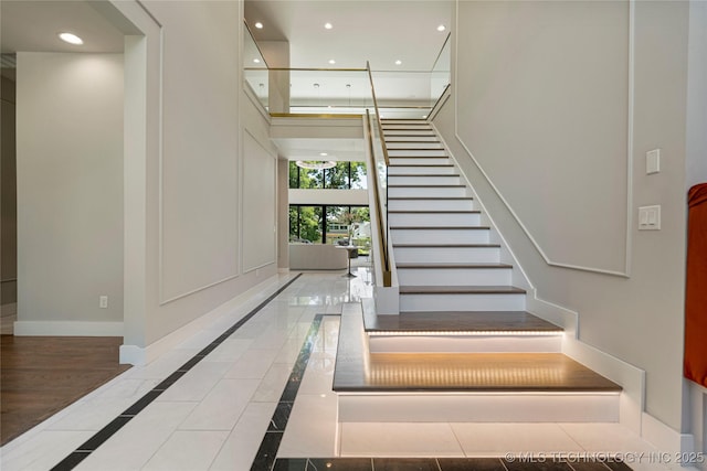 stairway with tile patterned floors