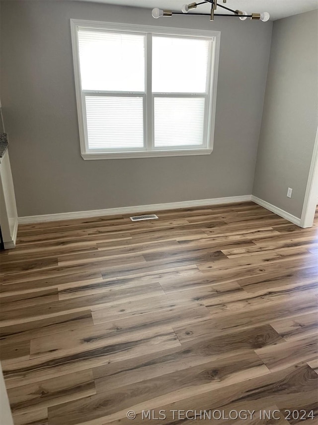 unfurnished dining area with hardwood / wood-style flooring and a healthy amount of sunlight