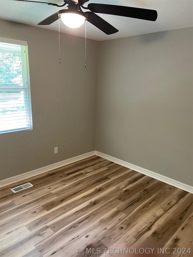 spare room with hardwood / wood-style floors and ceiling fan