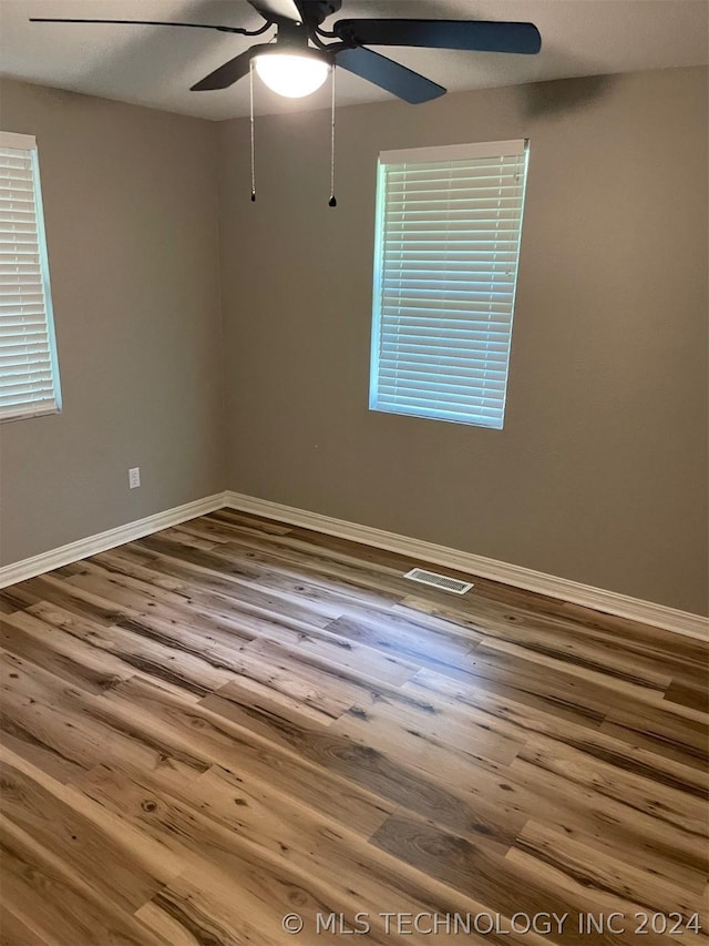 spare room featuring hardwood / wood-style flooring and ceiling fan