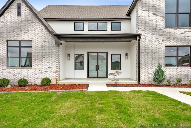 doorway to property with a yard