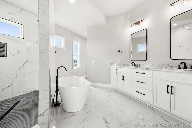 bathroom featuring shower with separate bathtub, a healthy amount of sunlight, and vanity