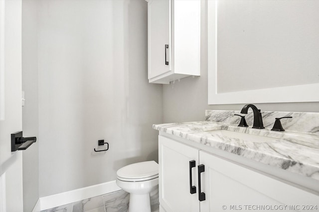 bathroom with toilet and vanity