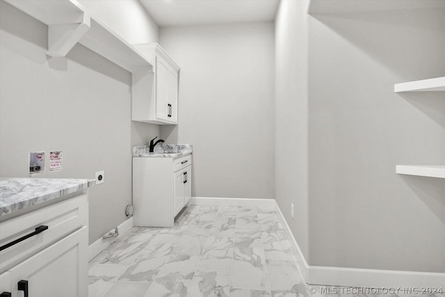 clothes washing area with cabinet space, baseboards, marble finish floor, washer hookup, and electric dryer hookup