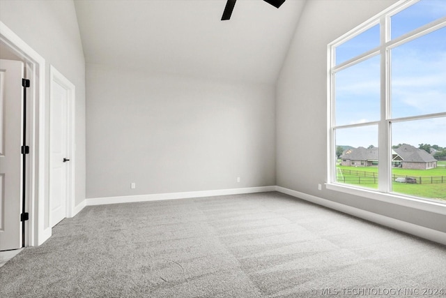 interior space featuring carpet floors, ceiling fan, and vaulted ceiling