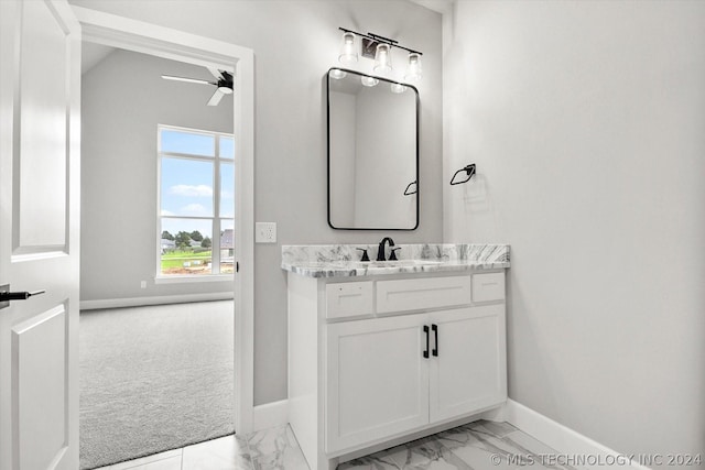 bathroom featuring marble finish floor, baseboards, a ceiling fan, and vanity