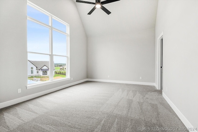 empty room featuring high vaulted ceiling, carpet floors, and ceiling fan