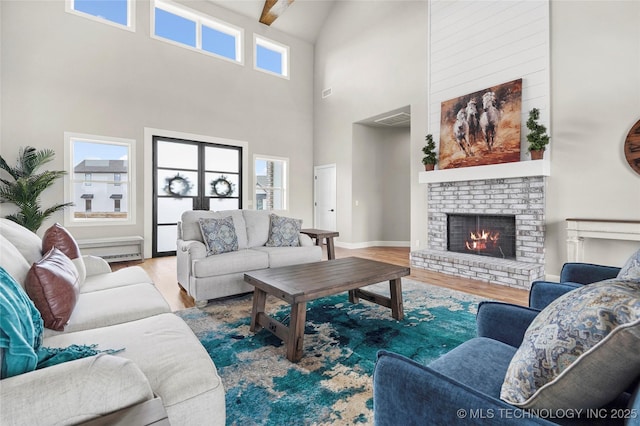 living room with plenty of natural light, visible vents, and wood finished floors