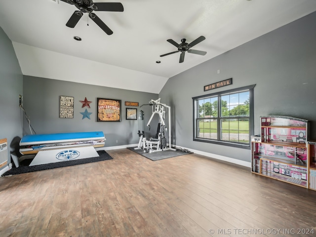 workout room featuring ceiling fan, vaulted ceiling, and hardwood / wood-style floors