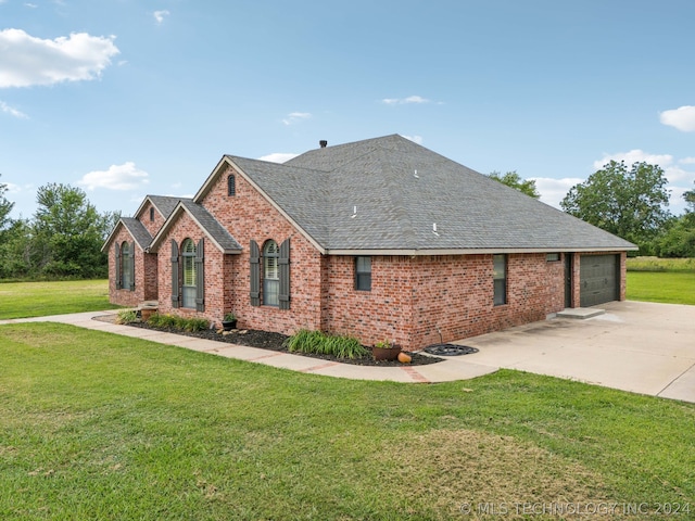 view of side of home featuring a yard and a garage