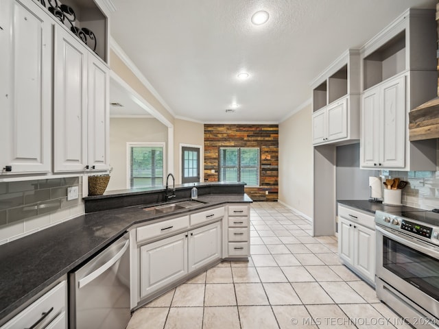 kitchen with stainless steel appliances, white cabinetry, and sink