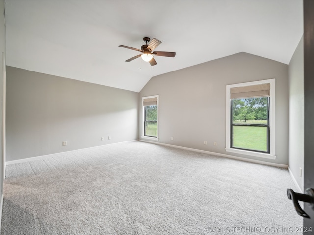 carpeted empty room featuring vaulted ceiling and ceiling fan