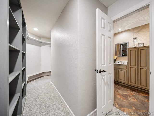 interior space featuring sink and dark carpet