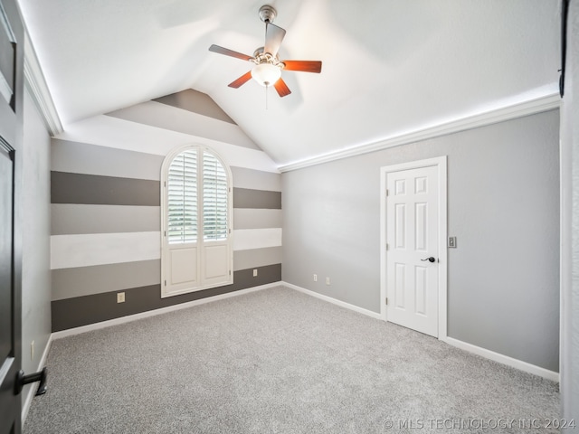 unfurnished bedroom featuring ceiling fan, vaulted ceiling, and carpet