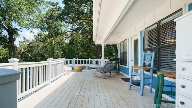 wooden terrace featuring a grill