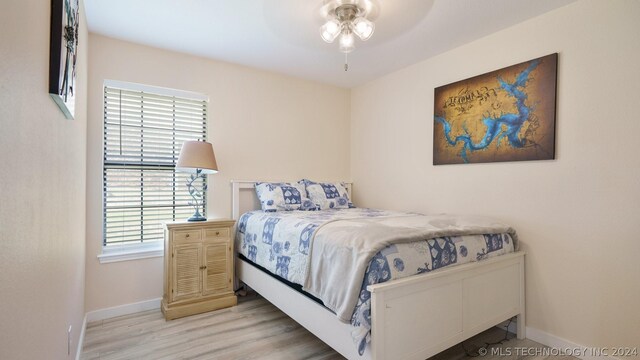 bedroom featuring light hardwood / wood-style flooring and ceiling fan