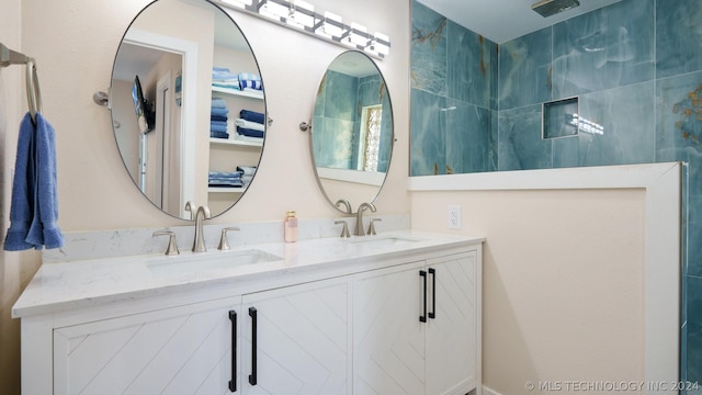 bathroom with vanity and a shower