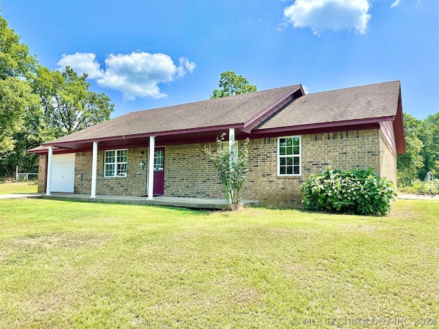 view of front of house with a garage and a front lawn