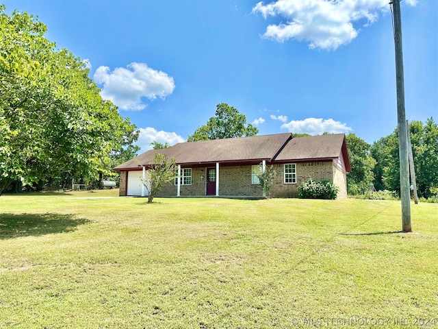 single story home featuring a garage and a front yard