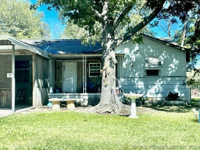 back of house with a yard