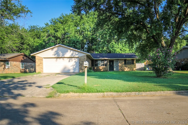 ranch-style home featuring a garage and a front yard