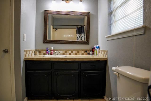 bathroom featuring vanity and toilet