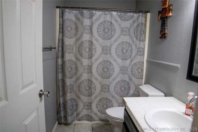 bathroom with vanity, toilet, and tile patterned flooring