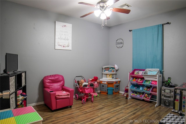 recreation room featuring ceiling fan and dark hardwood / wood-style floors