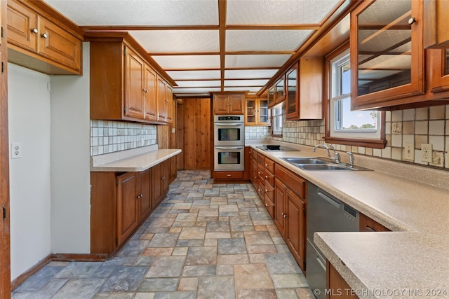 kitchen with stainless steel appliances, backsplash, and sink