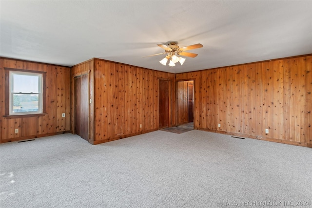 spare room featuring light carpet and ceiling fan