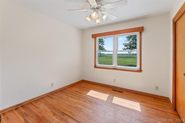 spare room with ceiling fan and light hardwood / wood-style flooring