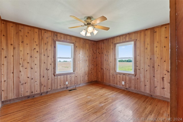 spare room with ceiling fan and hardwood / wood-style flooring