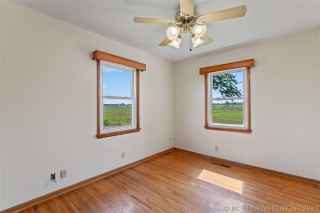 unfurnished room with ceiling fan and light hardwood / wood-style flooring