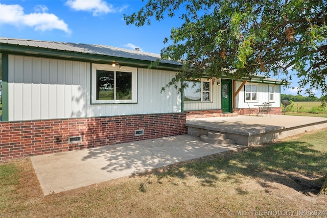 exterior space with a patio area and a yard