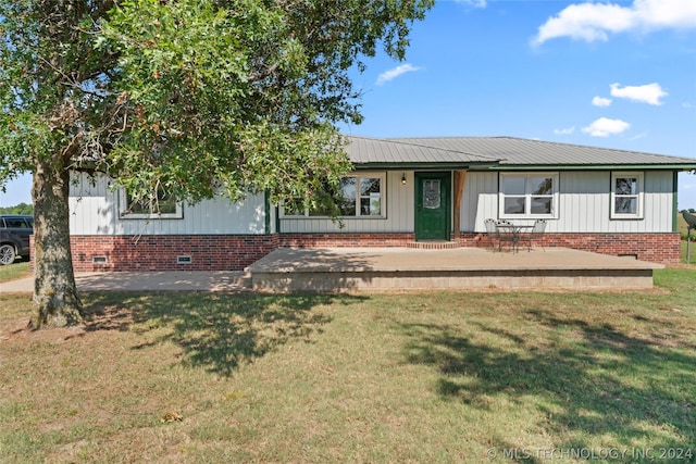 view of front of house with a patio area and a front yard