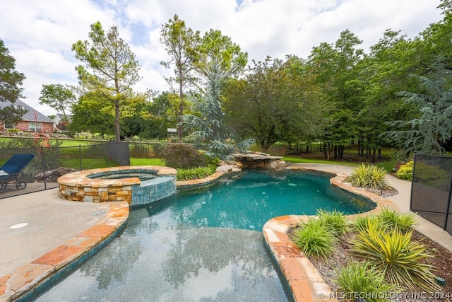 view of pool with an in ground hot tub