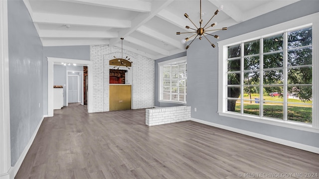 unfurnished living room featuring a chandelier, hardwood / wood-style flooring, and lofted ceiling with beams