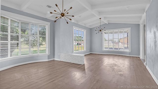 spare room featuring vaulted ceiling with beams, a chandelier, and hardwood / wood-style flooring