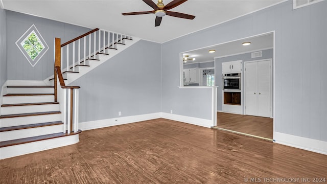 unfurnished living room with ceiling fan and hardwood / wood-style flooring