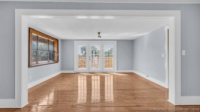 unfurnished dining area featuring hardwood / wood-style floors and french doors