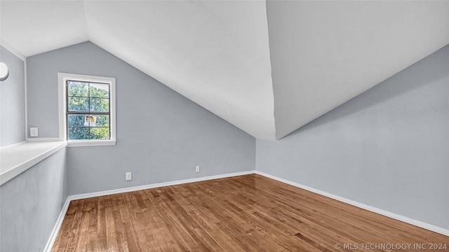 bonus room featuring lofted ceiling and hardwood / wood-style flooring