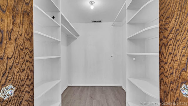 spacious closet featuring light wood-type flooring