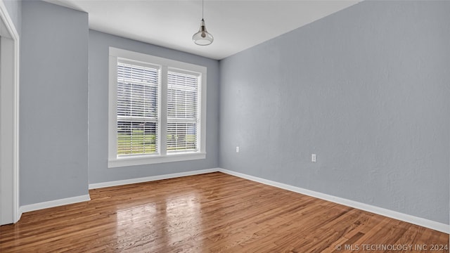 unfurnished room featuring hardwood / wood-style floors and a healthy amount of sunlight