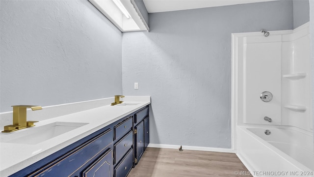 bathroom featuring bathing tub / shower combination, wood-type flooring, and vanity