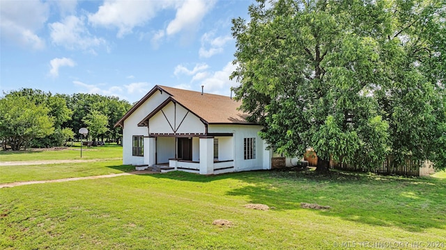 rear view of property with a lawn