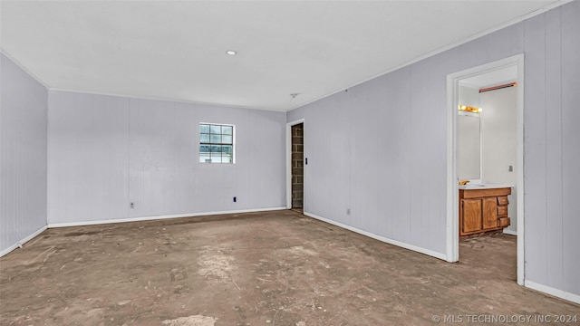 spare room with wooden walls