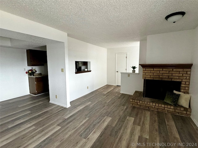 unfurnished living room featuring a textured ceiling, dark hardwood / wood-style flooring, and a fireplace