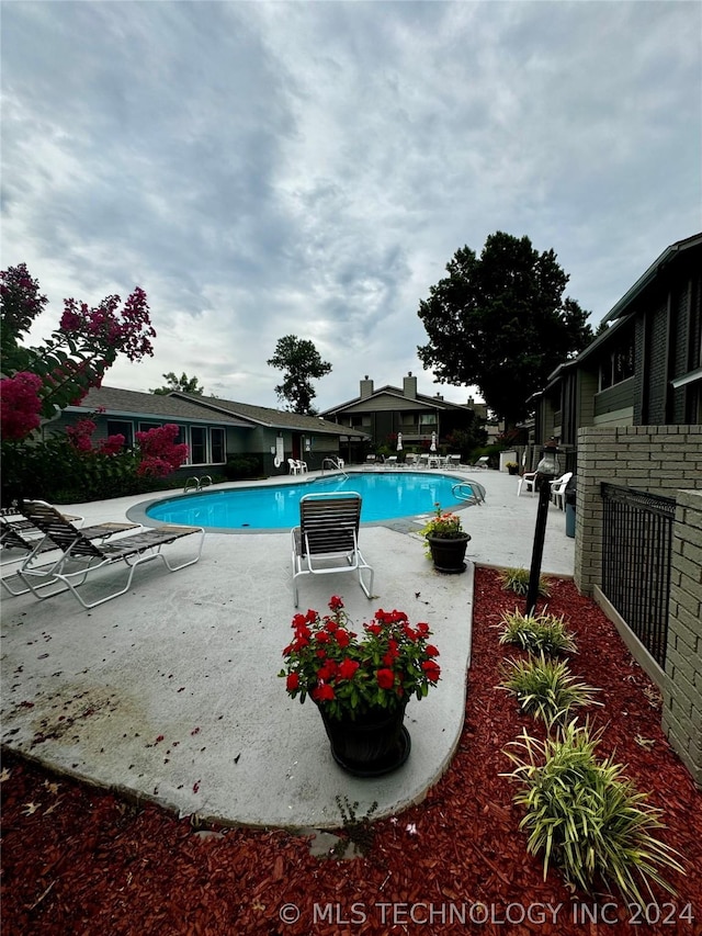 view of pool featuring a patio area